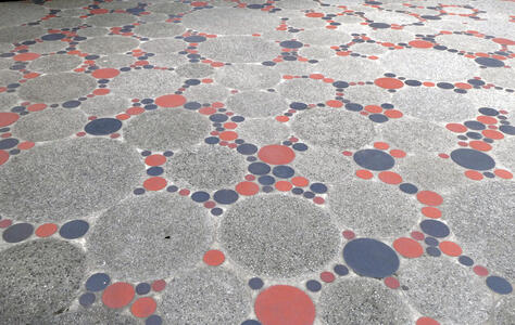 Gray circles of various sizes with smaller red and blue circles in the interstices