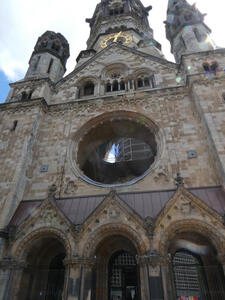 Shows gaping hole where large stained glass window would have been