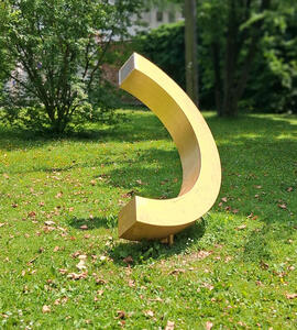 yellow C shaped sculpture