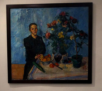 person seated near flowerpots