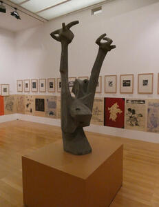 Abstract statue of person from waist up with arms upraised