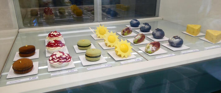 Pastries in shape of sun, large pistachio nut, and large blueberry