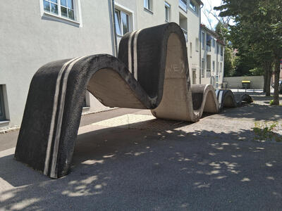 Gray stone sculpture in shape of a wave