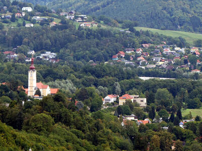Church at left; houses at right and in background