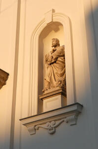 Niche with religious statue of bearded man in robe holding a book