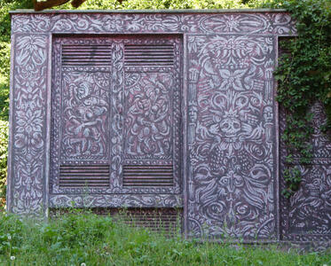 Utility building painted in purple with Mexican-style symbology