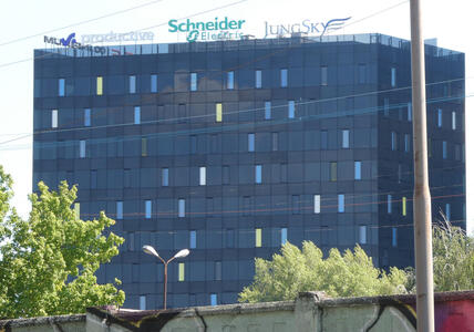 Building with windows that have yellow, blue, and white shades.