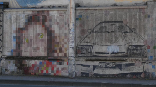At left, pixellated face; at right, drawing of a car with front facing the viewer