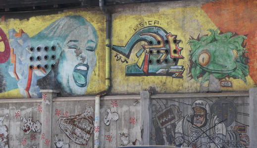 At left, a woman singing, mouth open. At right, a green gecko-like creature. Below the gecko, a person in a space suit.