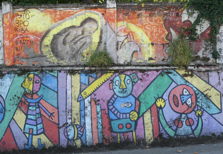 Above: Man crouched down; below: whimsical abstract people in various colors