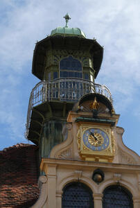 From top downwards: a cupola, the clock, and the doors of the glockenspiel.