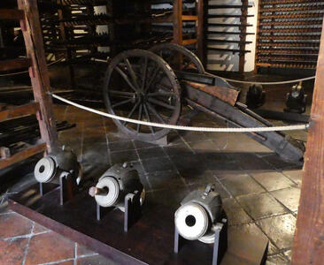 Small cannons in foreground, large cannon in background