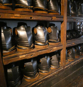 Three shelves of breastplates