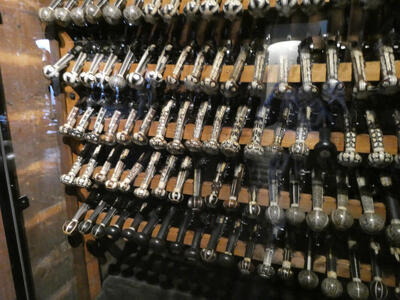 Rack of pistols with very fancy illustrated  handles