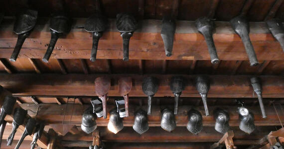Helmets and tools hanging from ceiling