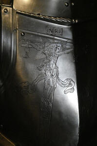 Engraving of Christ on a cross; engraving is on a suit of armor