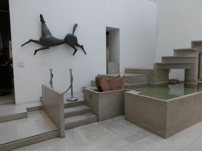 Abstract sculpture of horse on wall near museum entrance