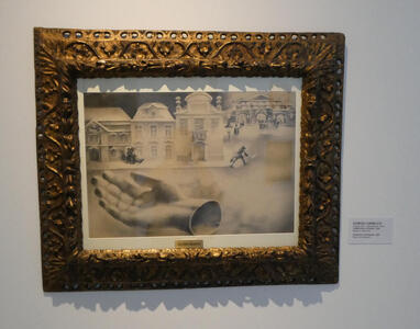 Painting of a street scene with a giant hand, palm upward, lying in the street