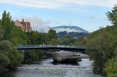 View of Mur Insel, an artificial island in the middle of the Mur river. There are low clouds in the background.