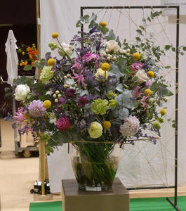 Floral arrangement with a profusion of different types and colors of flowers (green, yellow, white, red, pink, purple)