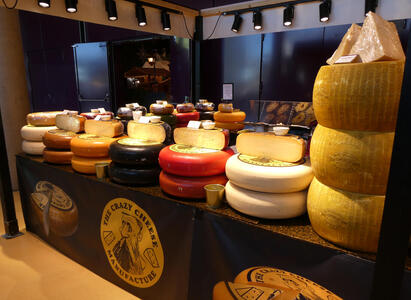 A view of enormous cheese wheels from an angle