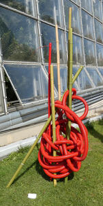 Bright red plastic tubing wrapped around a bamboo frame.