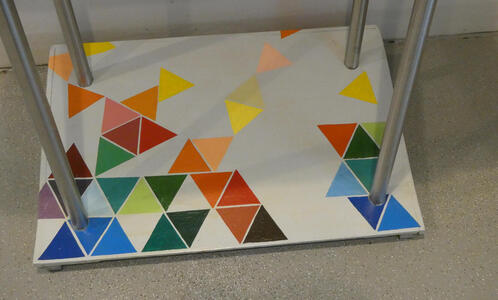 Base of table with colored triangles in a row at the bottom and then at random locations towars the top