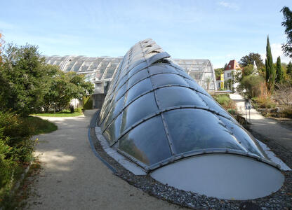 Botanical Garden building shaped like a cylinder tilted on its side, rising from the ground