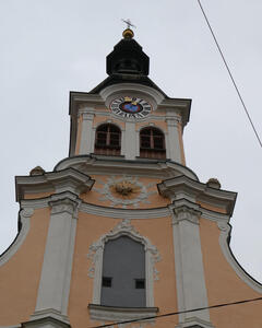 Clock at top of church; spire with cross above the clock