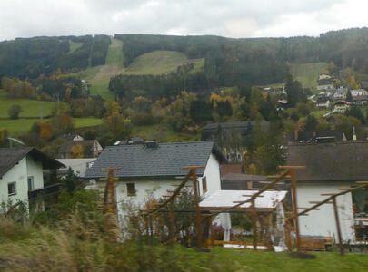 Small houses in foreground, rolling hills in background