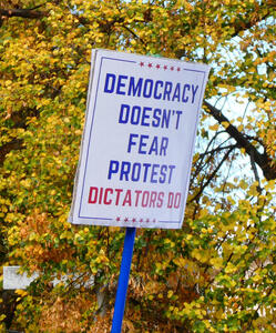 Sign: Democracy doesn’t fear protest / Dictators do