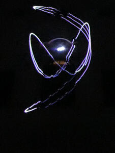 Lissajous figure projected on side of building