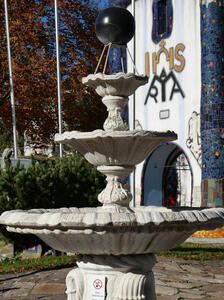 Three-level fountain with a black sphere on top
