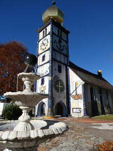 Fountain in foreground; church tower in background