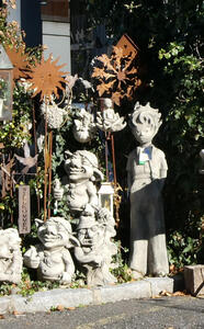 Garden ornaments of whimsical gnomes and a Tintin-like person