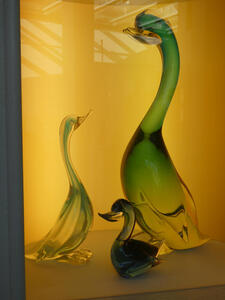 Large green goose and two smaller goslings