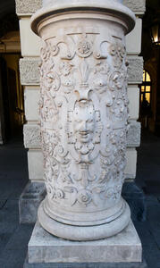 Pillar in front of Congress Center with a human face reliefwork, surrounded by decorative reliefwork.