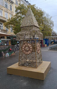Large framework in shape of Uhrturm, decorated with Christmas lights.