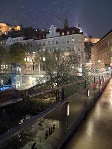 Snow falling; view is from a bridge near the Murinsel