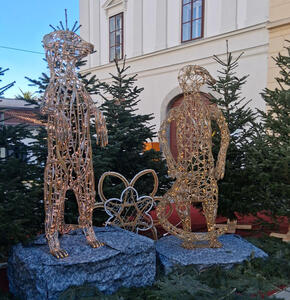 Two frameworks of animals with strands of lights throughout. One is a bear, the other an animal with a tail.