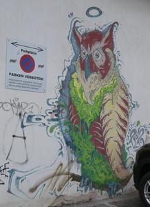 Wall painting of owl; red face, greenbody