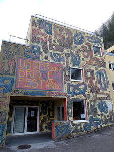 Abstract loop figures painted on side of building