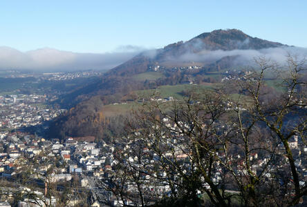 View from atop Mönchsberg; city in foreground, hills in background