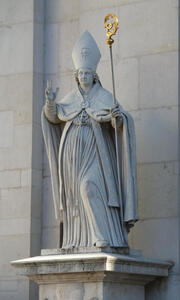 Statue of a bishop with mitre. In his hand, a shepherd’s staff with a gold top.