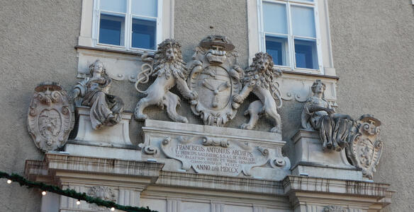 Carving of two lions holding a heraldic shield. A plaque beneath is dated 1610.