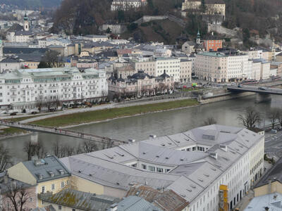 View of city; river runs horizontally through mid-ground.