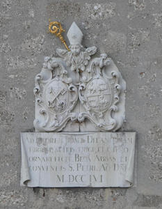 Plaque dated 1756; at top of plaque a cherub in bishop’s mitre with a gold staff