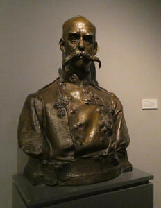 Bronze bust of bald man with very impressive handlebar moustache