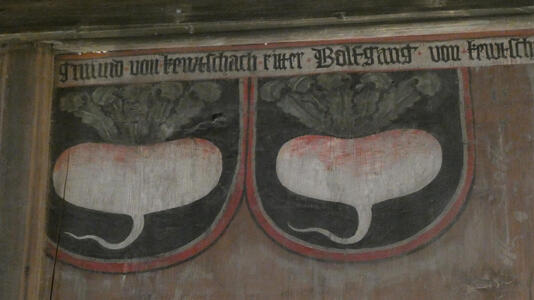 Painting of two shields with a radish (or turnip) on each one
