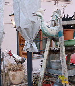 Carved wooden chickens as part of display outside a restaurant